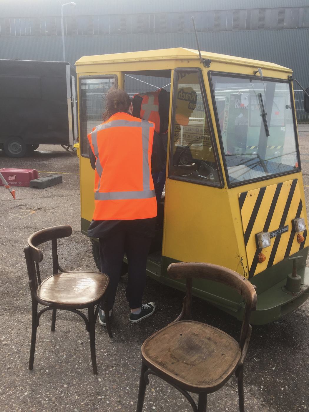 Working on a yellow electric cart