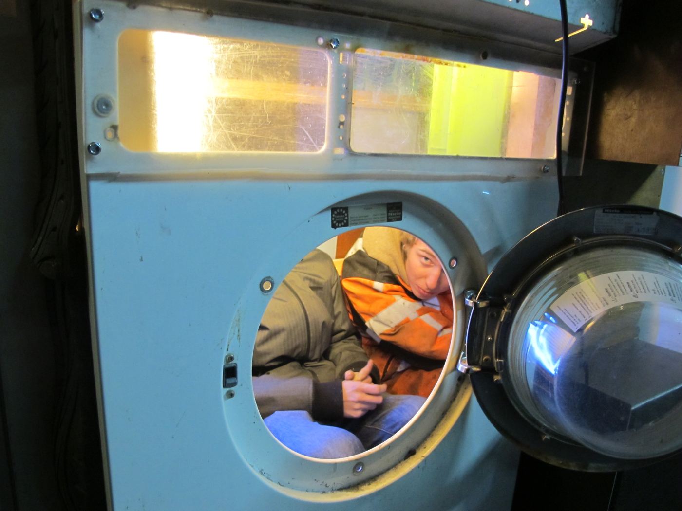 Someone framed in the round window, a washing machine drum