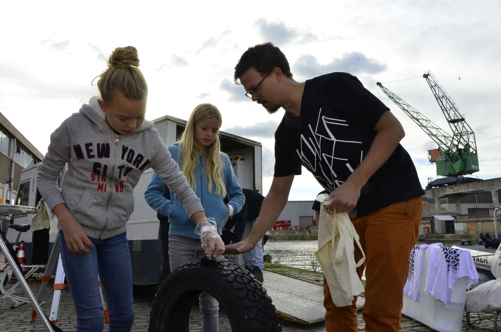 A team working on a tyre at the quay